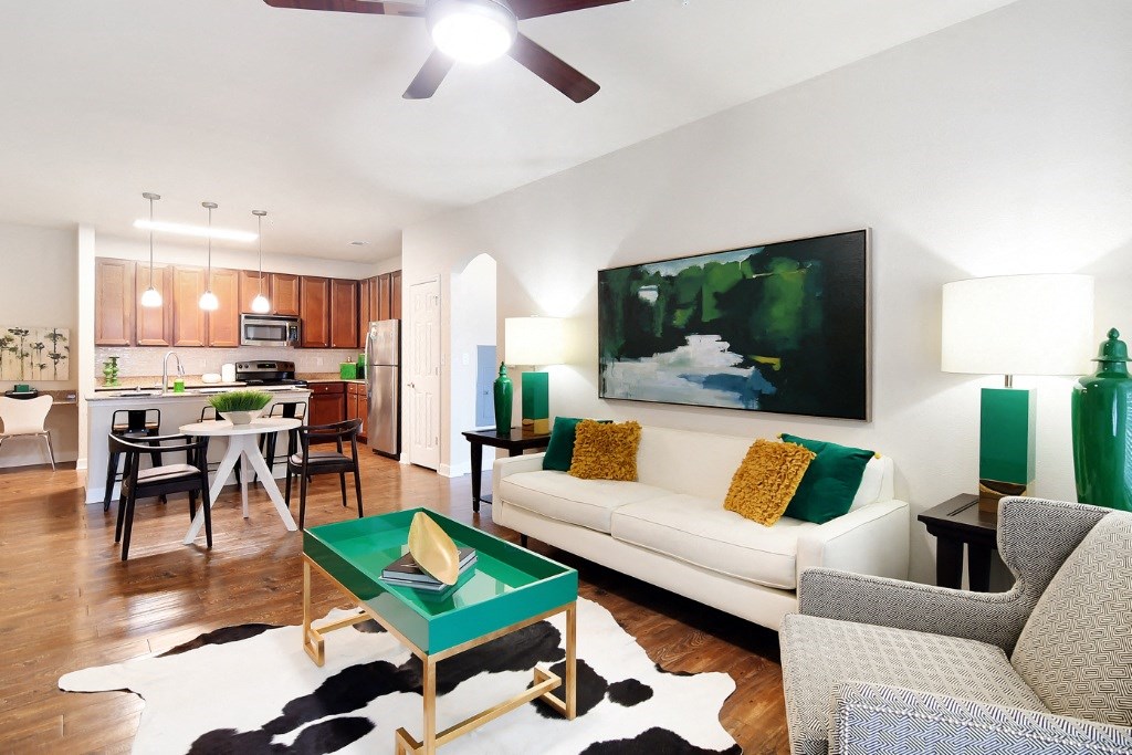 a living room with a white couch and a green coffee table at Faulkner Flats Apartment Homes, Oxford