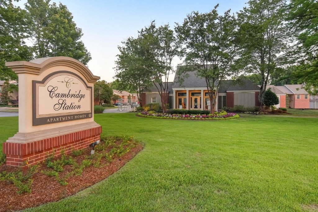 a large grassy area with a sign in front of it at Cambridge Station Apartment Homes, Oxford, MS, 38655