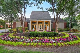 a house with a flower garden in front of it