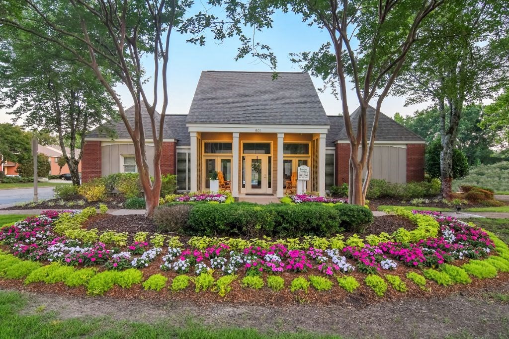 a house with a flower garden in front of it at Cambridge Station Apartment Homes, Oxford, MS