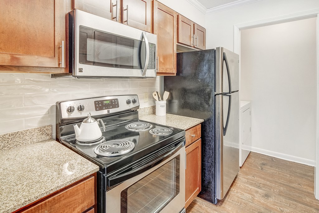 a kitchen with a stove microwave and refrigerator at Cambridge Station Apartment Homes, Oxford, 38655