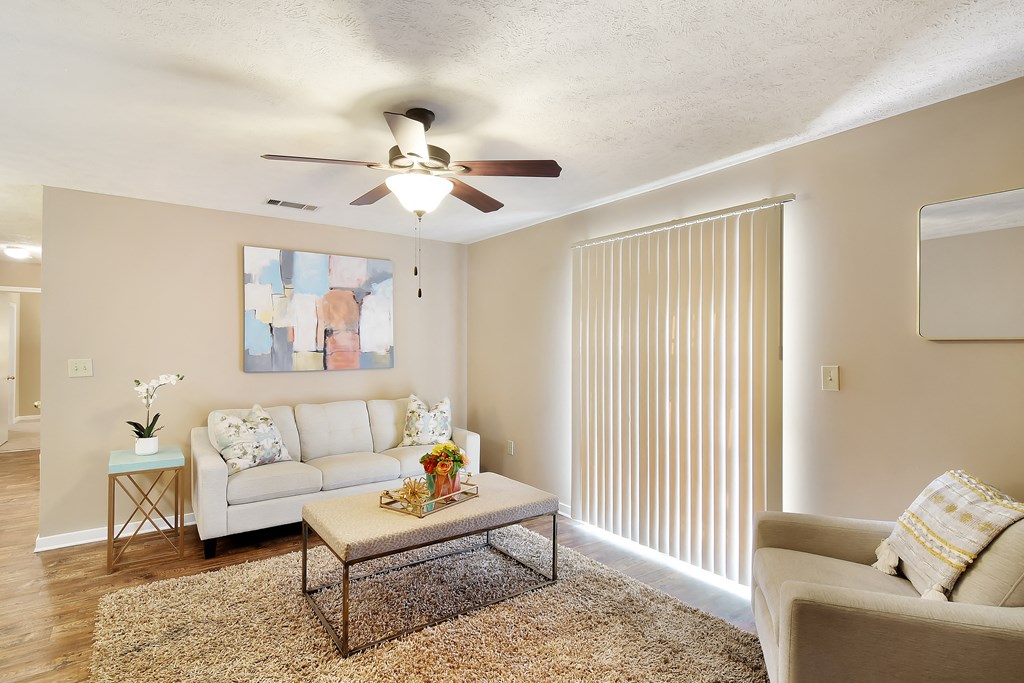 a living room with a ceiling fan and a couch at Parklane Apartment Homes, McComb, Mississippi