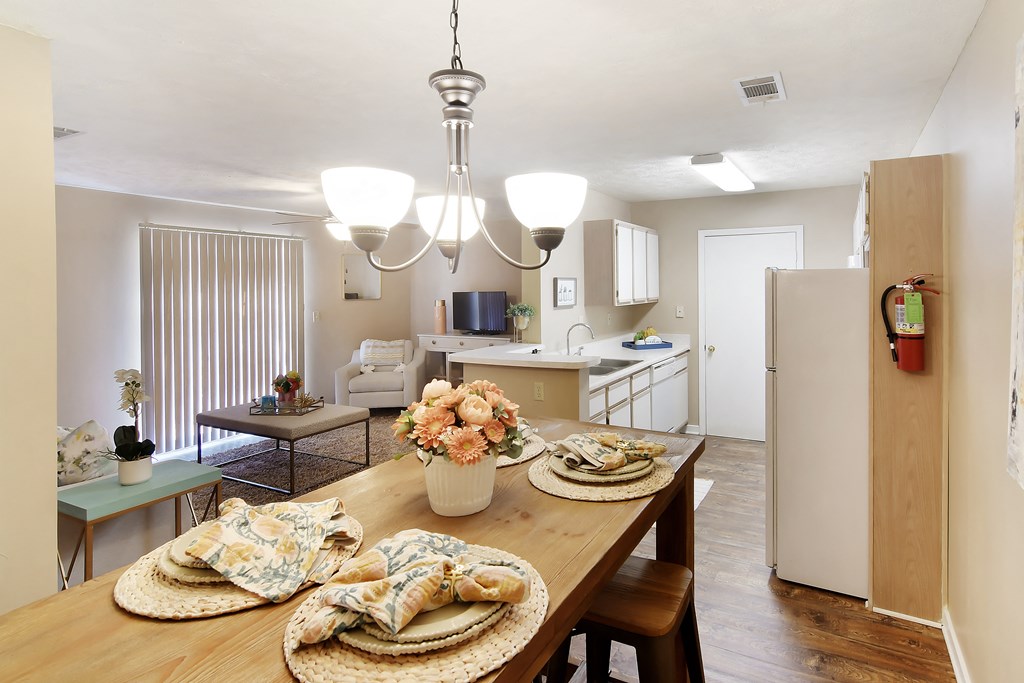 a kitchen and dining room with a table and chairs at Parklane Apartment Homes, McComb, 39648
