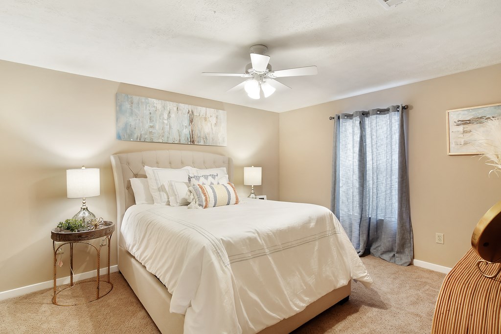 a bedroom with a large bed and a ceiling fan at Parklane Apartment Homes, Mississippi, 39648