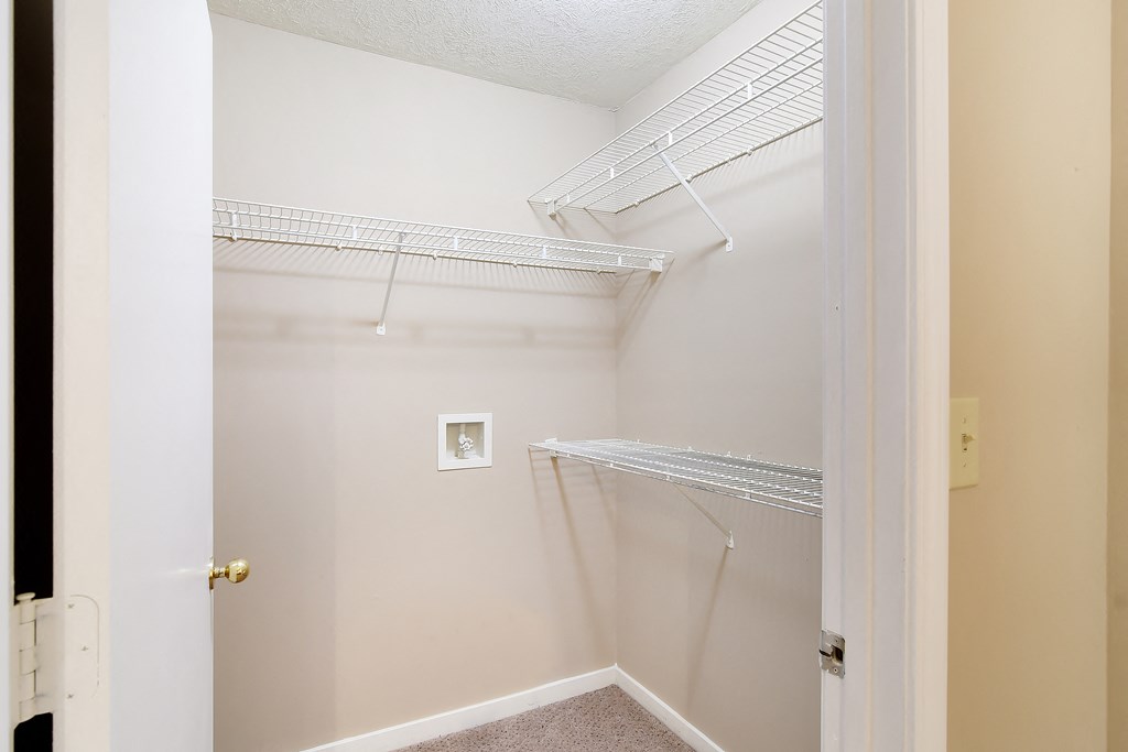 an empty closet in a home with white walls and a white door at Parklane Apartment Homes, Mississippi, 39648