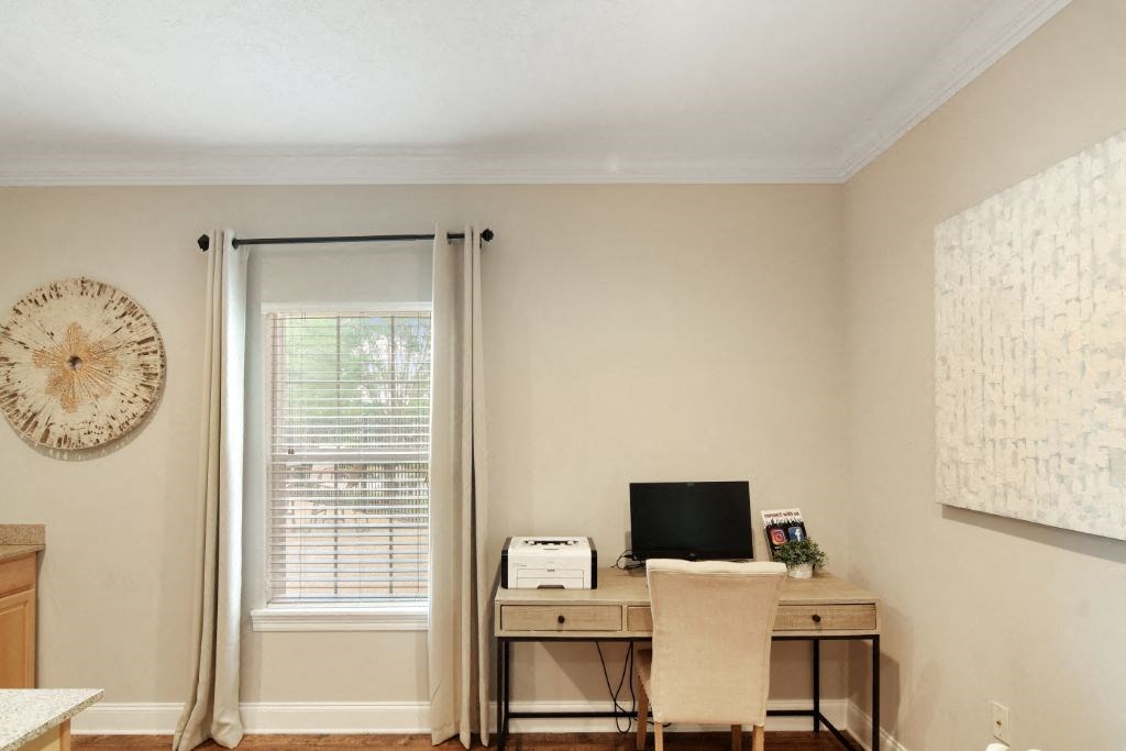 a home office with a desk and chair and a window  at Parklane Apartment Homes, McComb
