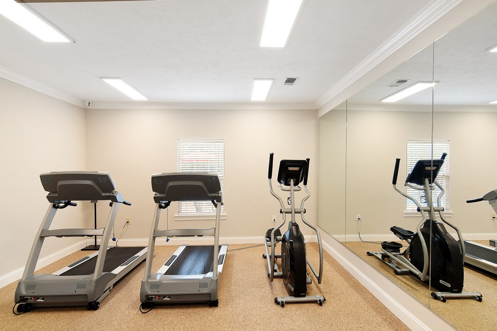 a gym with treadmills and other exercise equipment at Parklane Apartment Homes, McComb