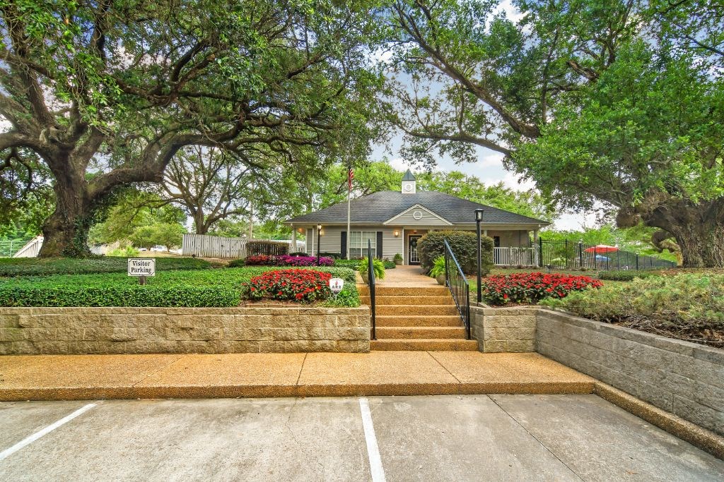 a house with a stone wall and steps leading up to it  at Parklane Apartment Homes, McComb