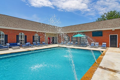 A pool with a fountain in the middle of it at Landing at Willow Bayou Apartment Homes, Bossier City, LA