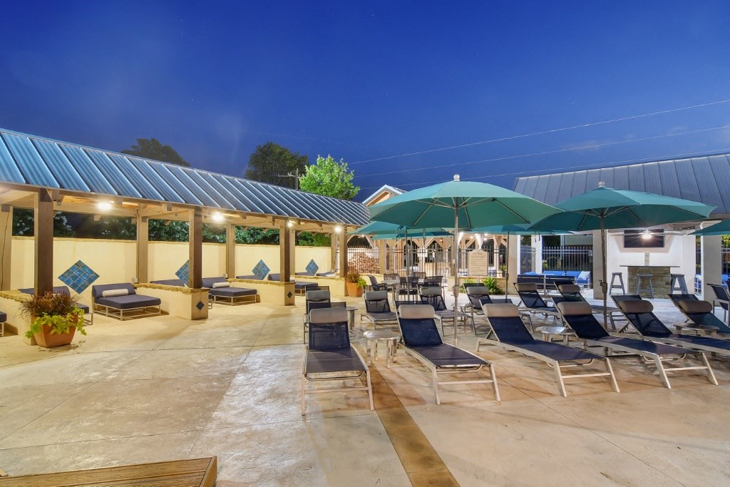 a patio with lounge chairs and umbrellas  at Landing at Willow Bayou Apartment Homes, Bossier City, LA, 71111