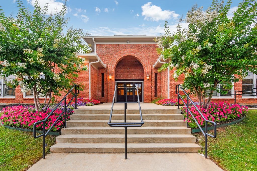 a brick building with a staircase in front of it at Cumberland Place Apartment Homes, Tyler, TX, 75703