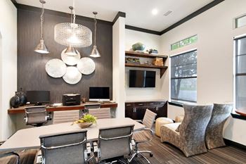 a conference room with a table and chairs and a tv in the corner of the room at Wellington Grande Apartment Homes, Longview