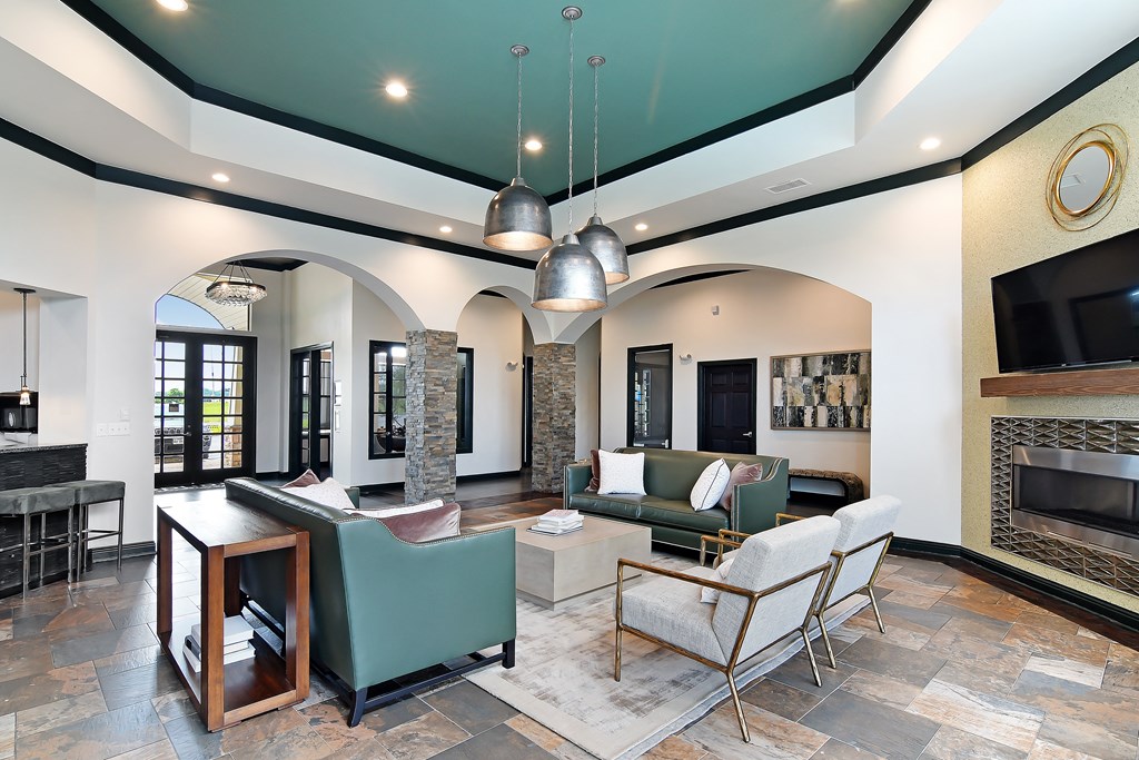 Courtyard living room with couches and chairs and a fireplace at Wellington Grande Apartment Homes, Texas, 75605