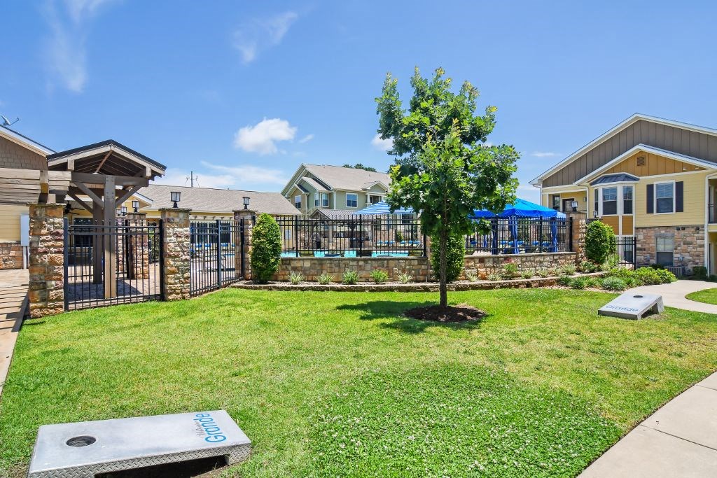 Wellington Grande corn hole courtyard  at Wellington Grande Apartment Homes, Longview, 75605