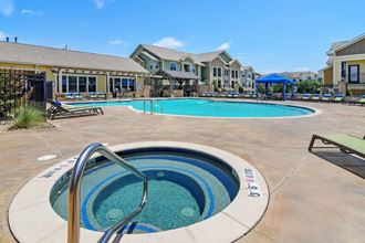 the preserve at ballantyne commons community pool and hot tub with apartment buildings in the background