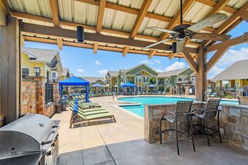 Grill area with relaxing area at Pool at Wellington Grande Apartment Homes, Longview, TX, Texas, 75605