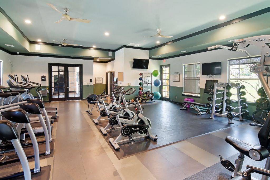 a room filled with lots of different types of exercise equipment  at Wellington Grande Apartment Homes, Longview