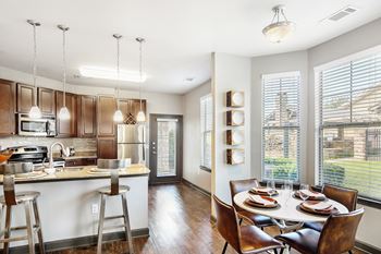 Clubhouse kitchen with a dining table at Wellington Grande Apartment Homes, Longview