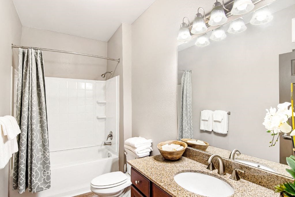 a bathroom with a sink toilet and shower  at Wellington Grande Apartment Homes, Longview, TX, 75605