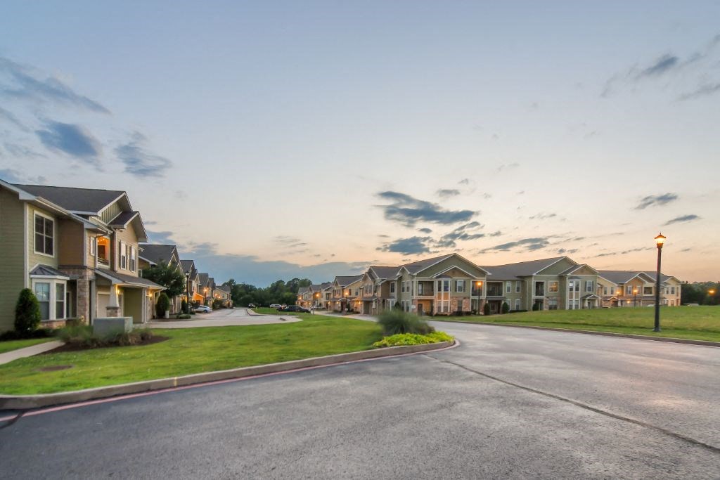 a street with rows of houses on either side  at Wellington Grande Apartment Homes, Longview, 75605