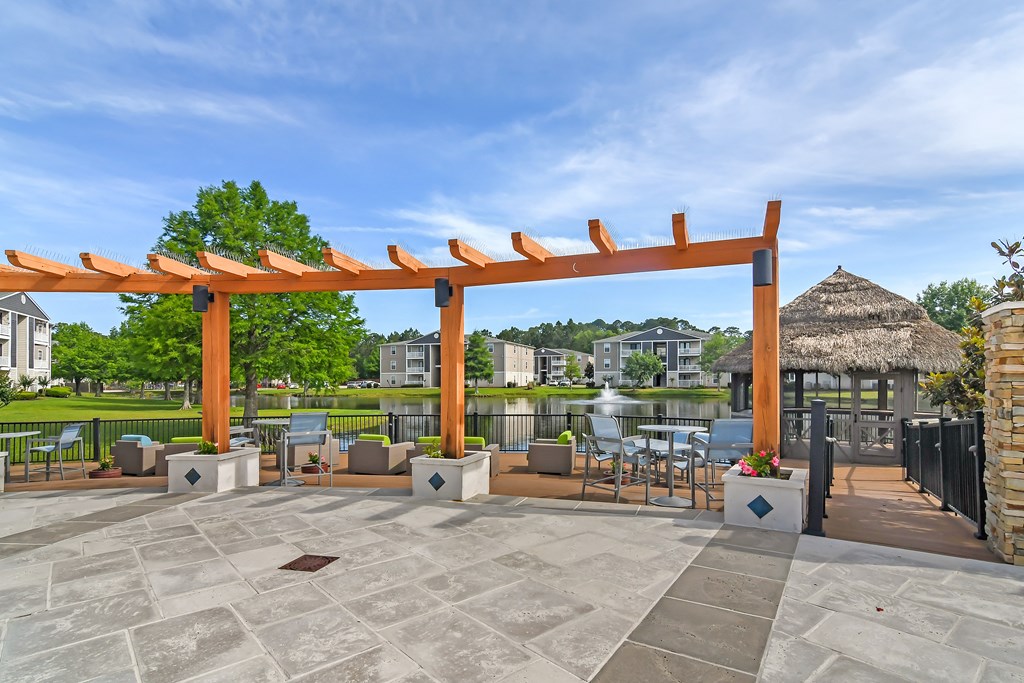 a covered patio with a gazebo and tables and chairs at Reserve at Gulf Hills Apartment Homes in Ocean Springs, 39564