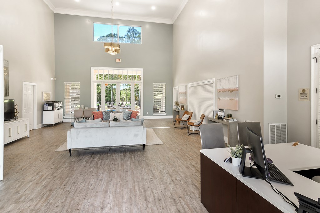 a living room with a couch and a table and a computer at Lagniappe of Biloxi Apartment Homes, Biloxi, Mississippi