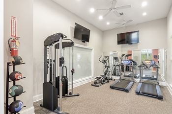 Gym with treadmills and other exercise equipment at Lagniappe of Biloxi Apartment Homes in Biloxi, MS