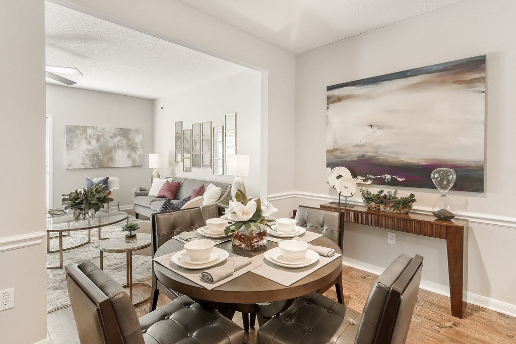 an open living room and dining room with a table and chairs at Lagniappe of Biloxi Apartment Homes, Biloxi, MS, Mississippi
