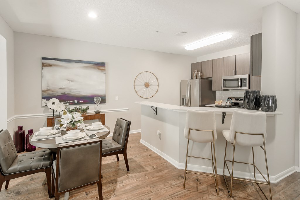 an open kitchen and dining room with a table and chairs at Lagniappe of Biloxi Apartment Homes, Biloxi, MS, Mississippi   , 39532