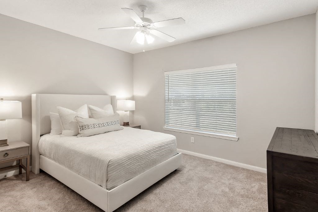 a bedroom with a bed and a window  at Lagniappe of Biloxi Apartment Homes, Biloxi, MS, 39532