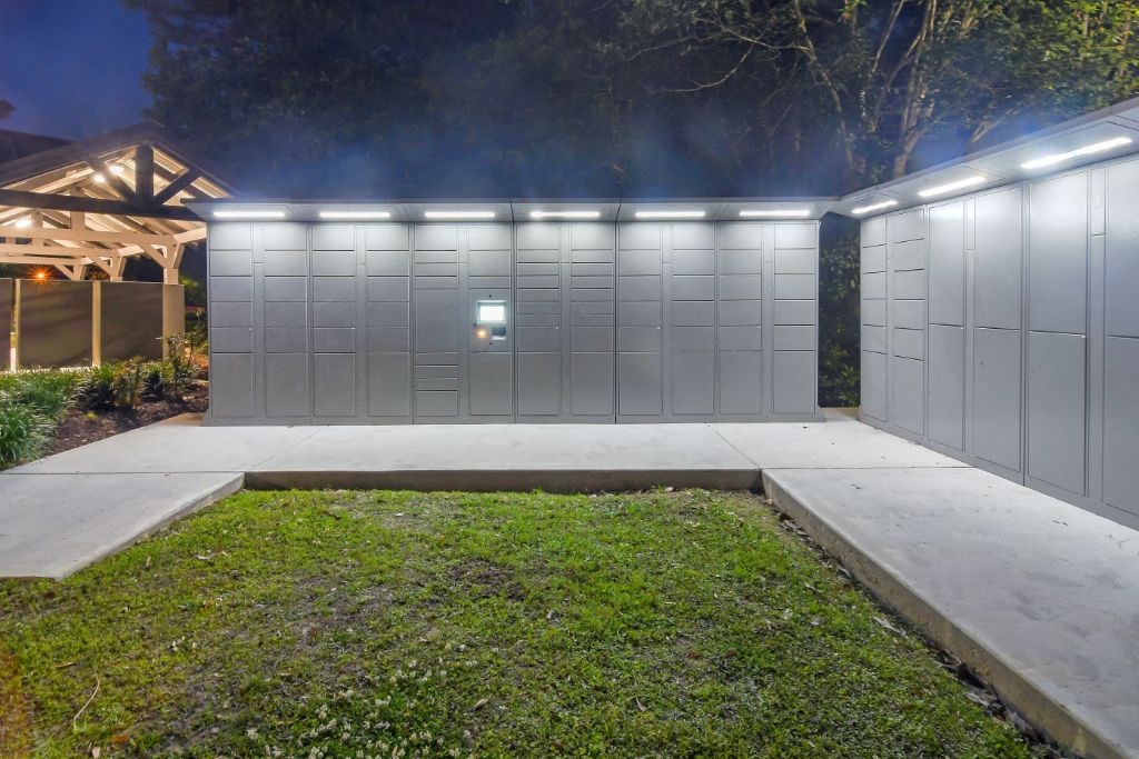 a house with a garage and a driveway with a lawn in front of it  at Lagniappe of Biloxi Apartment Homes, Mississippi