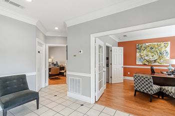 a living room and dining room with a table and chairsat The Pointe Apartment Homes, Gautier, MS