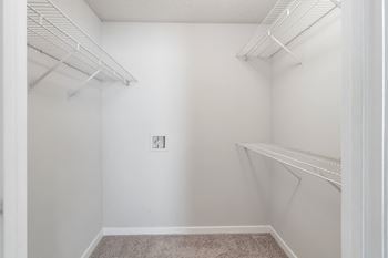 an empty closet with white walls and shelves and a white walled closet with shelvesat The Pointe Apartment Homes, Gautier, 39553