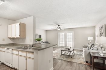 the preserve at ballantyne commons living room and kitchenat The Pointe Apartment Homes, Gautier, MS, 39553
