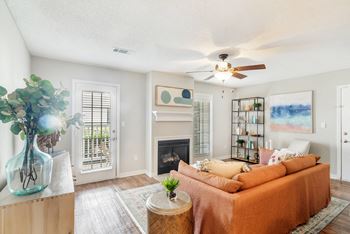 a living room with a couch and a ceiling fan at Reserve of Jackson Apartment Homes, Jackson