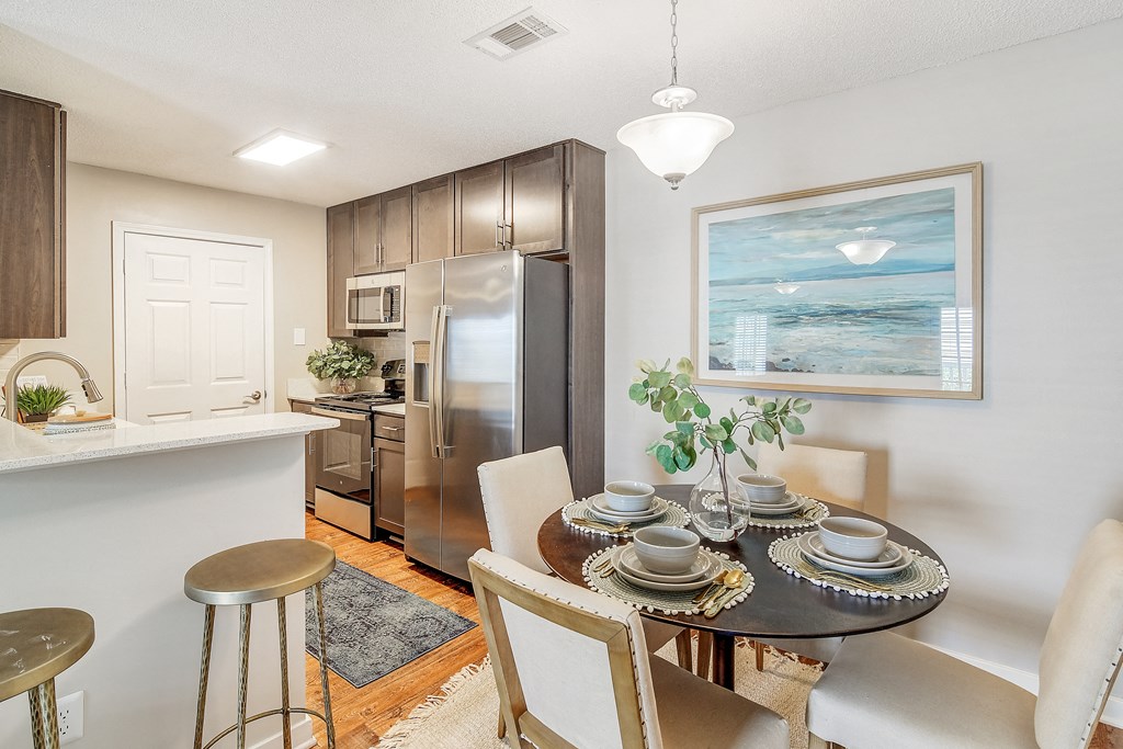 a kitchen and dining room with a table and chairs at Reserve of Jackson Apartment Homes, Mississippi, 39211