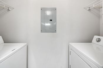 a washer and dryer in a white laundry roomat The Pointe Apartment Homes, Gautier, MS