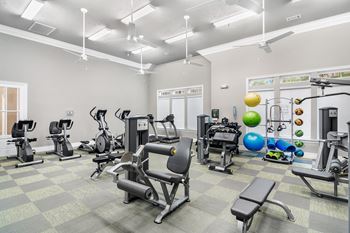 our state of the art gym is filled with cardio equipment and weights at Charleston Apartment Homes, Mobile, Alabama