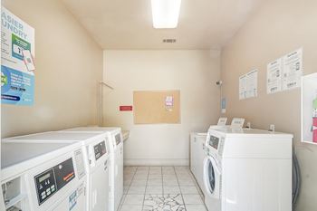 a laundry room with four washes and dryers in it at Reserve of Jackson Apartment Homes, Jackson, MS, 39211