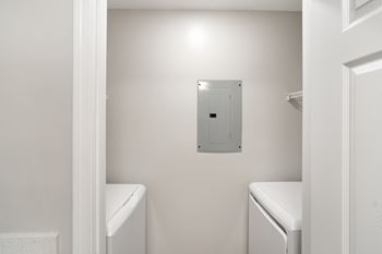 a white laundry room at The Woodlands Apartment Homes, Meridian