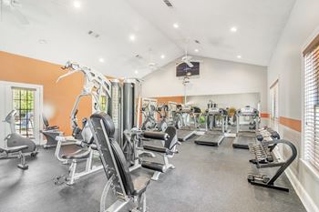 A well-equipped gym with various exercise machines and weights at Reserve of Jackson Apartments