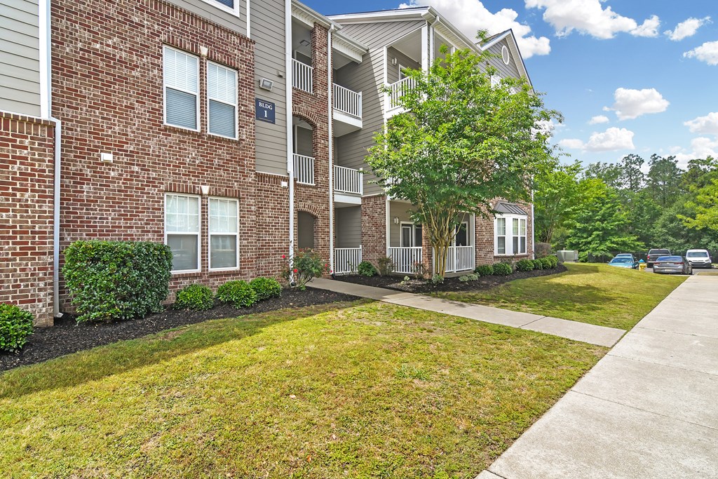 our apartments at the district feature a spacious living area and a walkway at Charleston Apartment Homes, Mobile, Alabama