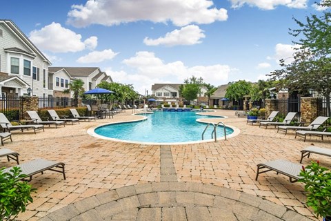 the preserve at ballantyne commons community pool with lounge chairs and umbrellas