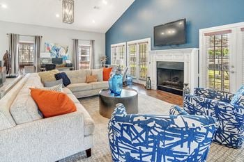 a living room with blue and white furniture and a fireplace at Reserve of Jackson Apartment Homes, Mississippi, 39211