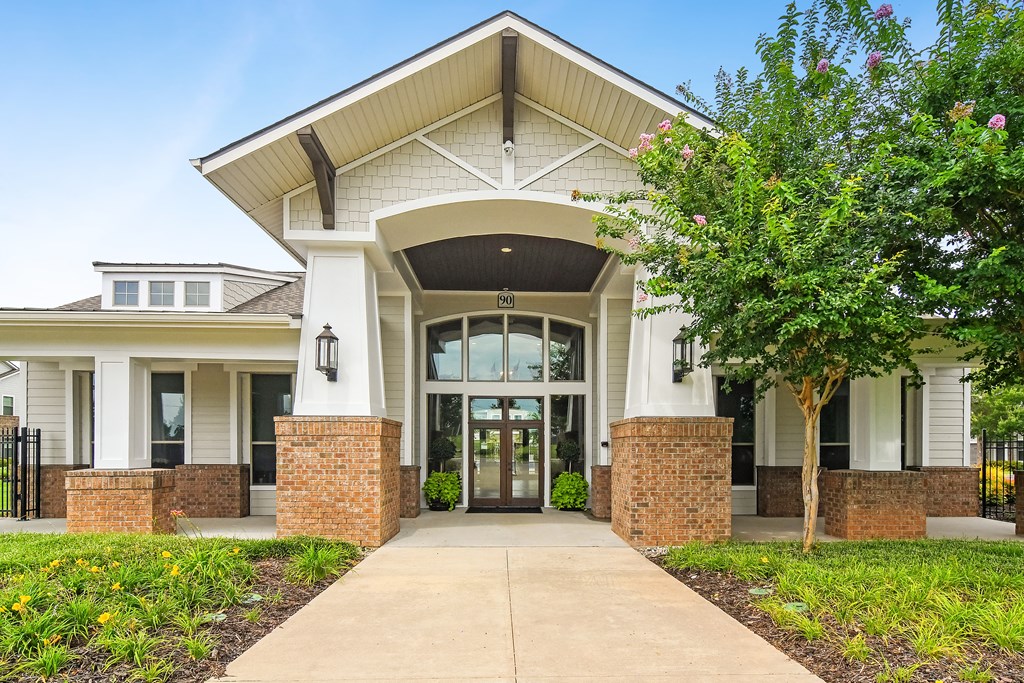the view of the front of a building with a sidewalk and trees at Kingston Crossing Apartment Homes, Bossier City, LA, Louisiana