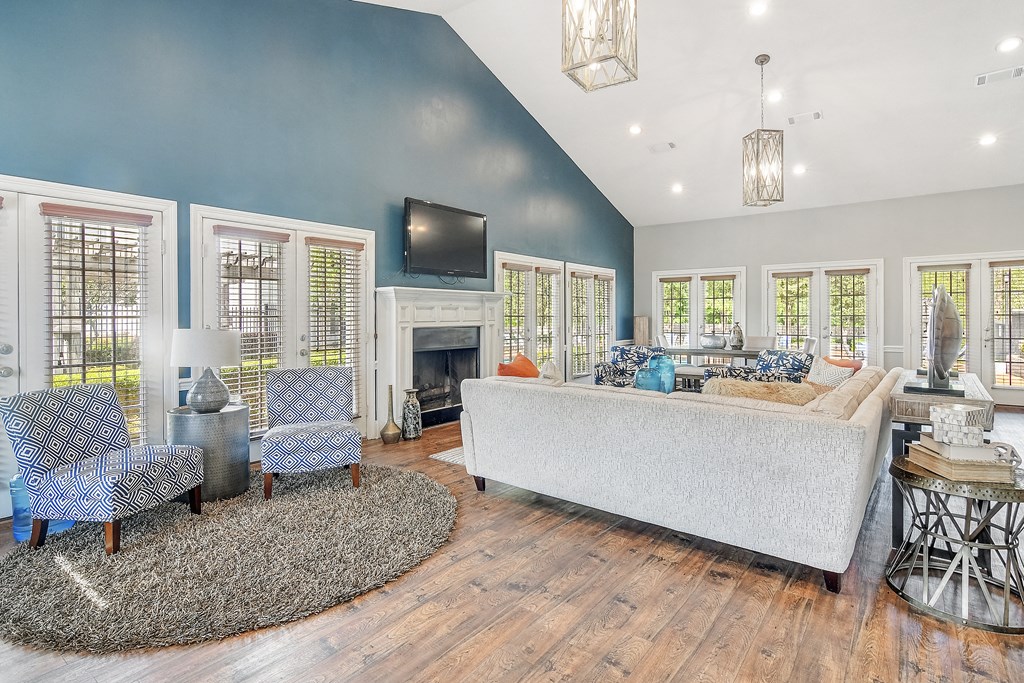 a living room with blue walls and a fireplace at Reserve of Jackson Apartment Homes, Jackson, MS
