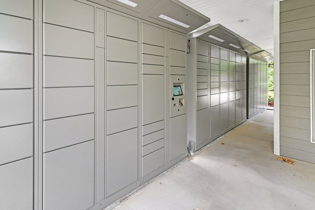 a row of lockers in a hallway of a building at Charleston Apartment Homes, Alabama 36695