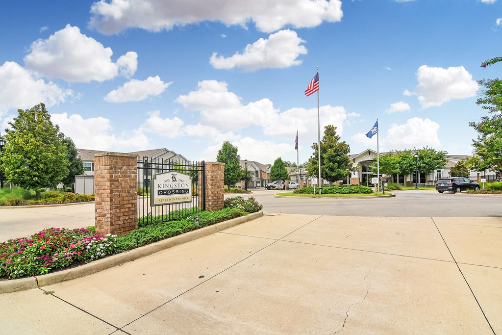 the preserve at ballantyne commons community entrance with a gate and flags at Kingston Crossing Apartment Homes, Bossier City, LA