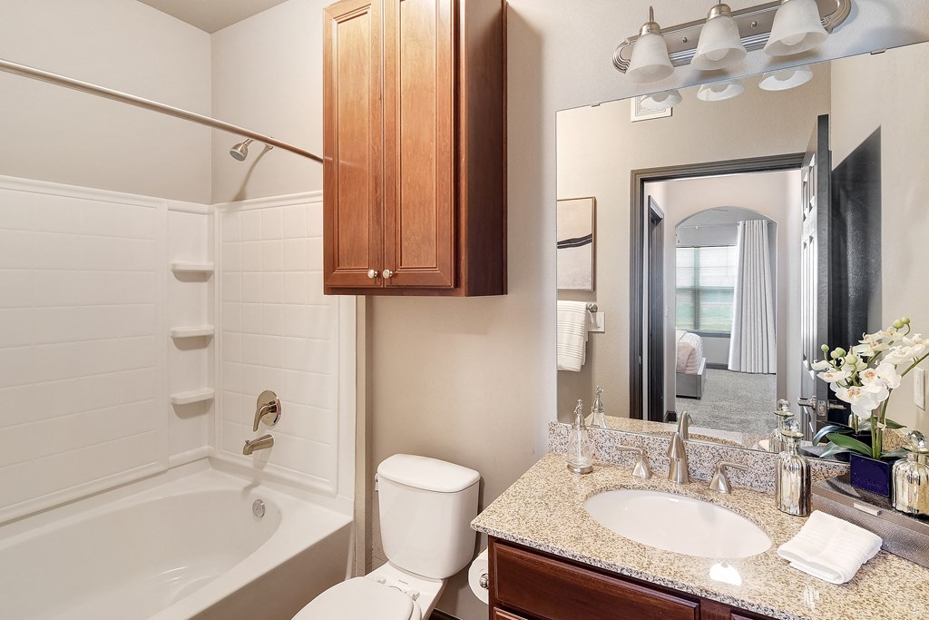 a bathroom with a sink toilet and shower and a mirror at Kingston Crossing Apartment Homes, Bossier City, LA, Louisiana  , 71111