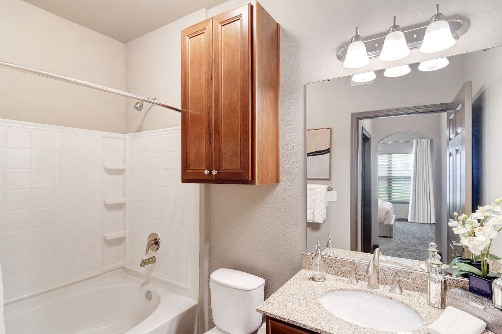 a bathroom with a sink toilet and bathtub  at Kingston Crossing Apartment Homes, Bossier City